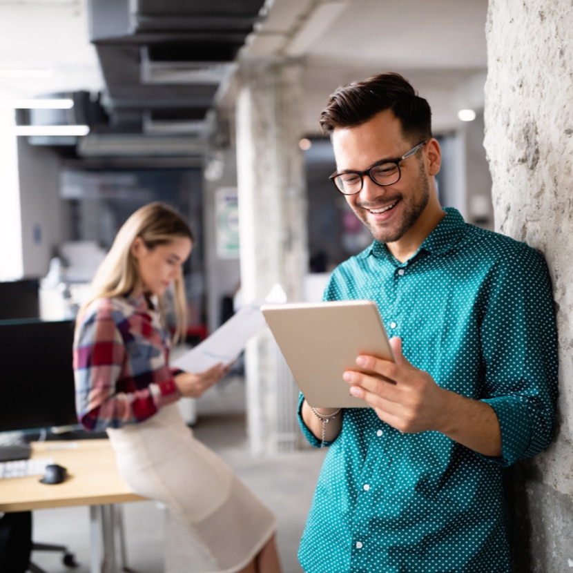 Person smiling looking at a tablet